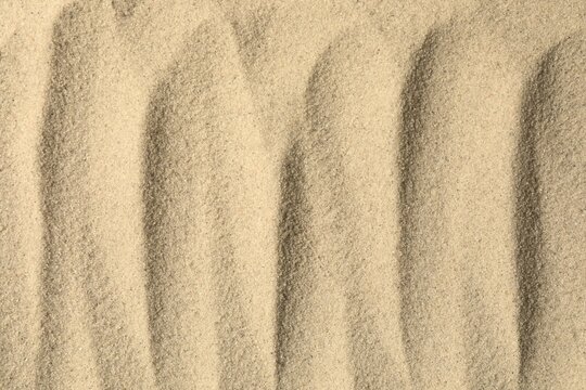 Natural sand texture background, beige sand surface.