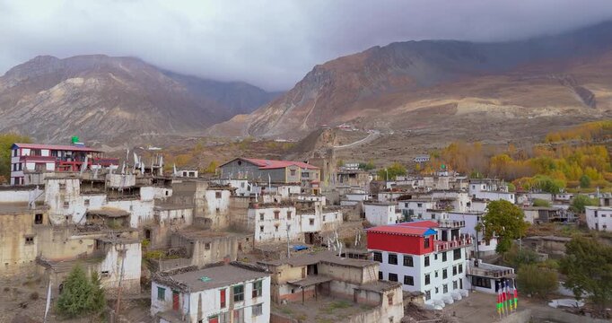 Annapurna Circuit,Mustang Nepal, aerial glide shot over the traditional whitewashed and red-roofed stone buildings of Jharkot village on the unique, arid terrain of the Himalayan desert valley