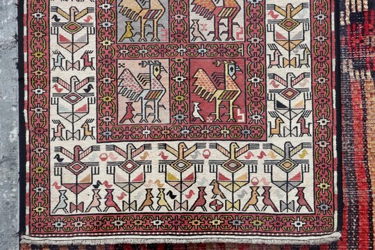 A detail of a carpet featuring traditional motifs. An example of the Turkish art of hand-weaving, showcasing geometric and floral patterns.