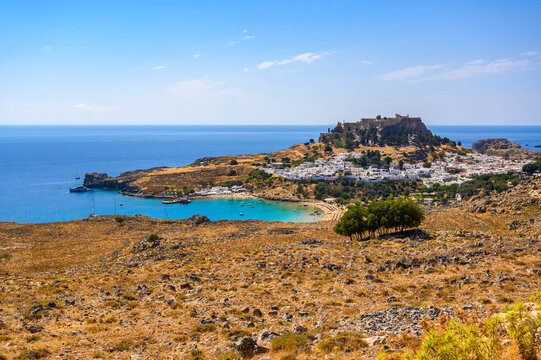 Traditional Lindos Harbor and Whitewashed Village on Rhodes Island, travel destination in Greece;