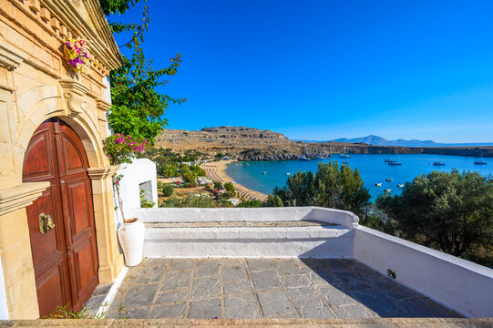 Traditional Lindos Harbor and Whitewashed Village on Rhodes Island, travel destination in Greece;