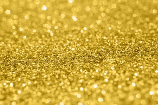 Abstract gold glitter sparkle texture with bokeh background