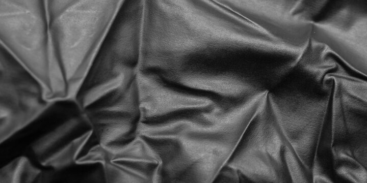 Abstract Black Rubber Latex Texture Background with Elegant Folds and Shadows