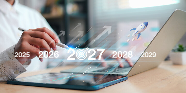 Business professional planning future growth with a digital tablet, laptop, rocket, arrows, and 2027 timeline, symbolizing business strategy, innovation, startup growth, goals,