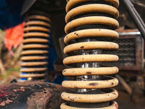 Yellow Vehicle Suspension Coil Spring with Rust Spots
