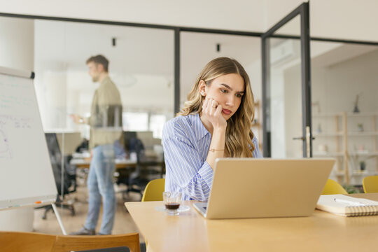 Stressed businesswoman works on financial task in modern office