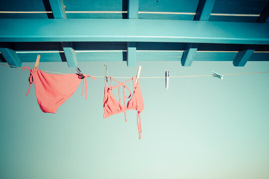 Bikini hanging on clothes line under the roof