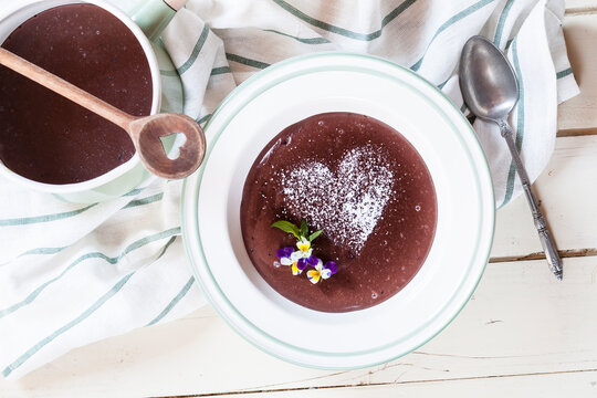 Chocolate pudding decorated with edible flowers