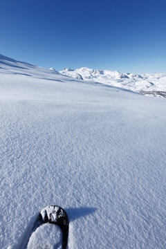 Austria, Upper Austria, Snowshoe on snow, mountains in background