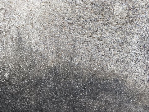 A close-up shot of a weathered concrete surface and rough textures.