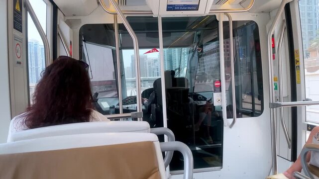 Inside the modern Dubai Tram as it arrives at Sobha Realty Station, showcasing its sleek, contemporary interior design.