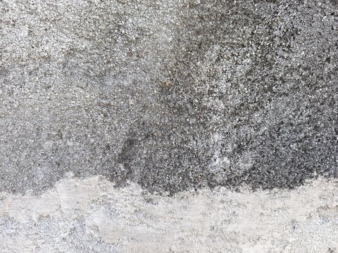 A close-up shot of a weathered concrete surface and rough textures.
