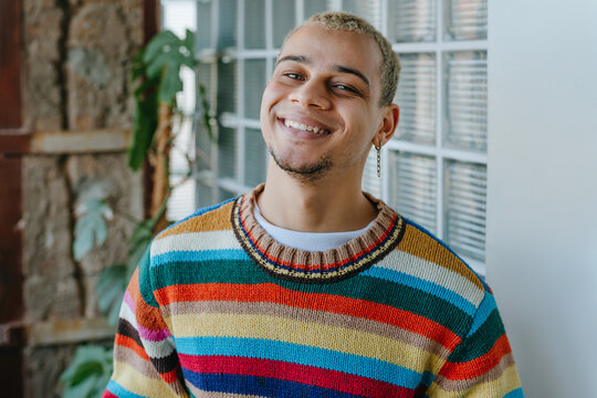 Smiling businessman wears a colorful sweater in the modern office