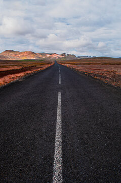 Iceland, Europe: view of the breathtaking Icelandic landscape from the road. Trip on the road, asphalt, book cover, symbolic, freedom, travel 