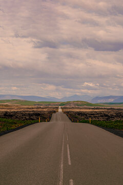 Iceland, Europe: view of the breathtaking Icelandic landscape from the road. Trip on the road, asphalt, book cover, symbolic, freedom, travel 