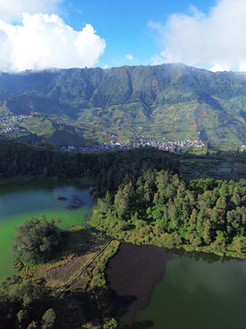 Aerial drone footage of Telaga Warna (Color Lake) on the Dieng Plateau, Central Java, Indonesia, captured during the late afternoon golden hour