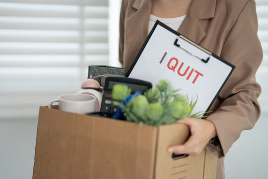 resignation, leave, quit, Stressful businesswomen will resign from the company. Female staff is lifting a brown paper box that holds personal items. , job placement and vacancies, resignation letter