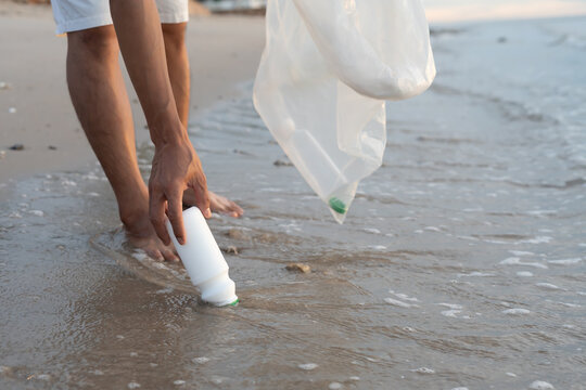 Save water. Volunteer pick up trash garbage at the beach and plastic bottles are difficult decompose prevent harm aquatic life. Earth, Environment, Greening planet, reduce global warming, Save world