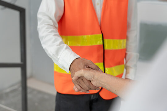 Engineer team hands shaking greeting start up plan new project contract in office center at construction site, industry ,architecture, partner, teamwork, agreement, property, contacts.