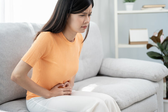 stomach ache. Asian women have abdominal pain, indigestion, gastritis, menstrual cramps, flatulence, diarrhea, distention, colon cancer, belly inflammation problem, suffer food poisoning, abdomen