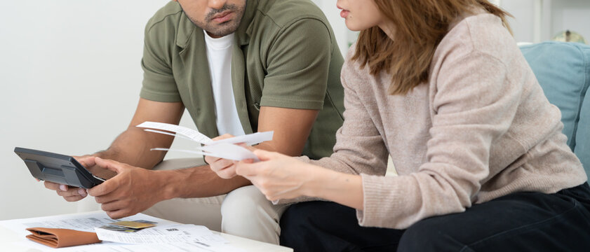 Stressed and headache asian couple with large bills or invoices no money to pay to expenses and credit card debt. shortage, Financial problems, mortgage, loan, bankruptcy, bankrupt, poor, empty wallet