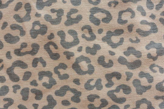Beige knitted fabric with gray leopard print pattern