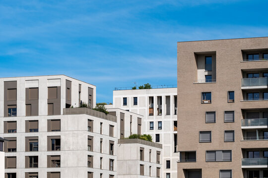 Modern apartment buildings in Lyon with residential architecture rising against blue sky as geometric facades define the contemporary urban skyline