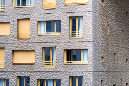 Residential architecture in Lyon reveals a modern apartment building facade with windows and geometric texture repeating across the urban exterior