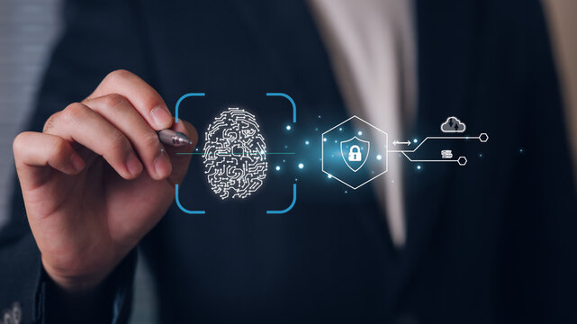 A business professional interacts with a virtual digital fingerprint and security icons, symbolizing cybersecurity, data protection, and advanced security technology in a modern digital environment.