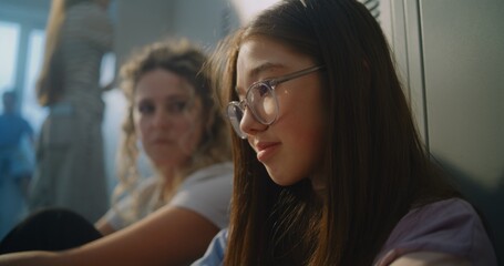 Fototapeta premium Teacher Sit beside Discouraged Teenage Girl, Offering Calm Guidance and Emotional Reassurance before School Day Continues. Mentorship, Student Care, Psychological Safety, and Positive School Culture.