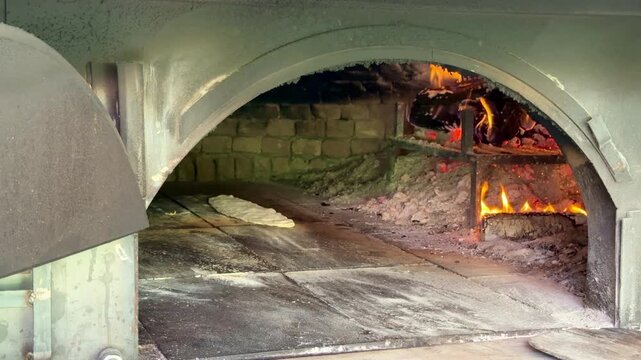 Black Sea-style pide baked with wood fire in a stone oven. Kastamonu, Turkey. 4K video.
