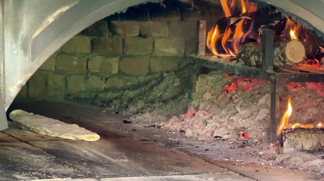Black Sea-style pide baked with wood fire in a stone oven. Kastamonu, Turkey. 4K video.
