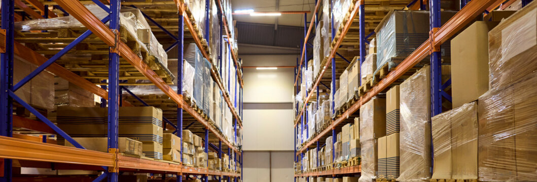 Warehouse aisle with shelves pallets boxes racking inventory. Clean storage supports accurate logistics and timely distribution across operations daily. Clear concept of reliable supply chain.