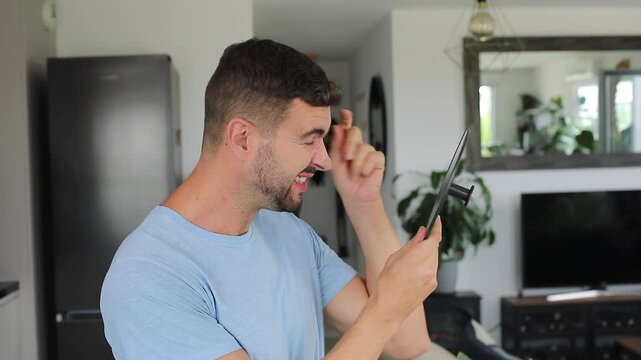 A 40 year old man observing his crow feet and forehead wrinkles using a mirror 