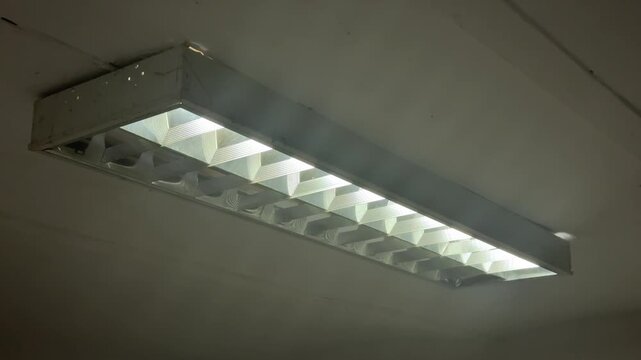 Fluorescent ceiling light fixture in a worn interior