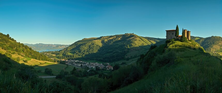 Panorama of Hillside Village and Ancient Tower at Dawn with Clear Sky
