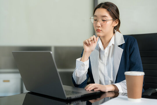 stressed asian businessman working in the office. Businesswoman thinking too much work concept in the office.