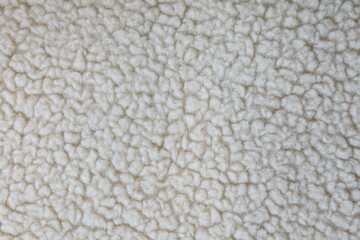 Detailed macro texture of white curly sheep fur background © Krzysztof