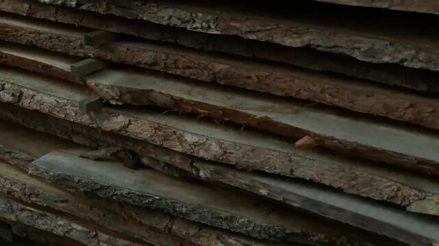 Stacked rough-sawn timber planks in a lumber yard