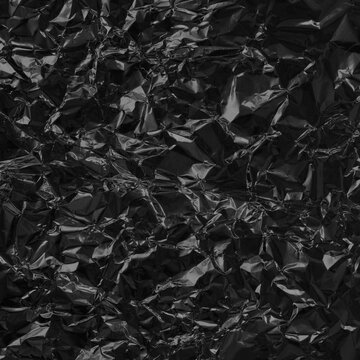 Shiny black grey foil metal texture, abstract wrapping paper for background and design art work.