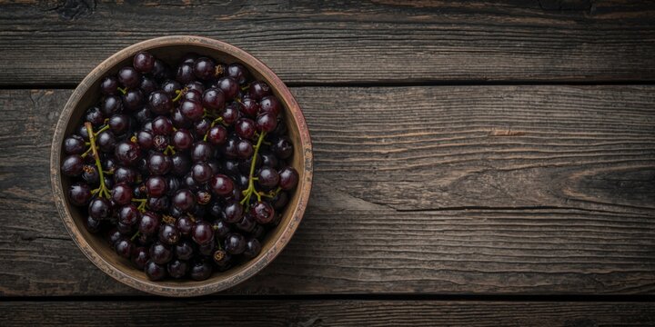 Fresh Grapes in a Wooden Bowl on a Rustic Tabletop