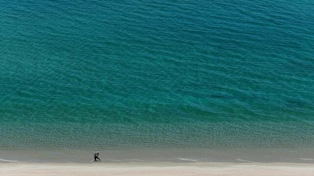 Aerial view of a fly fisherman walking on the beach in La Ventana, Sea of Cortes.