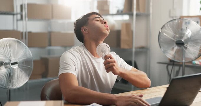 Logistics, laptop and man with fan for hot weather, heatwave and cool down with air flow in office. Computer, person and heat stress, summer fatigue and humidity problem in distribution startup