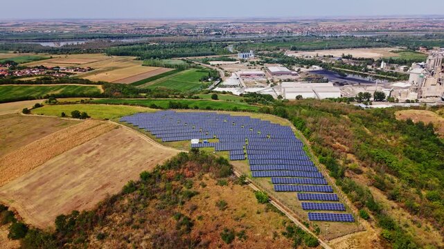 Aerial view of solar farm with rows of photovoltaic panels set in a rural landscape near Beocin, Vojvodina, Serbia.
