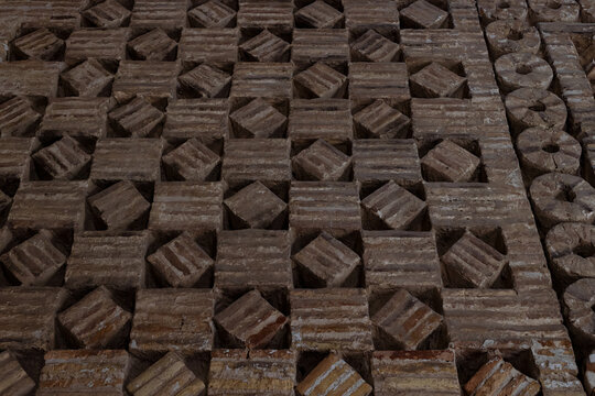 Decorative brickwork detail of the Ismail Samani Mausoleum in Bukhara showing geometric patterns. Historic Islamic architectural ornamentation ideal for heritage and travel publications.