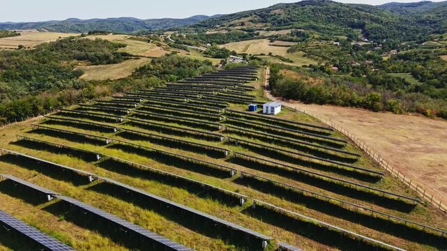 Aerial view of solar farm with rows of photovoltaic panels set in a rural landscape in Beocin, Vojvodina, Serbia.