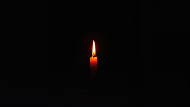 Single Candle Flame Glowing in Darkness with Soft Warm Light