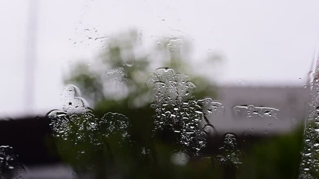 Car windshield with rain drops and frameless wiper blade,Traffic Jam with raining in evening day in the city,Drops of water on the car after rainy,outside car,Raindrops falling on a glass