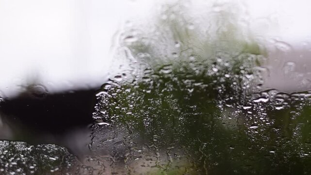 Car windshield with rain drops and frameless wiper blade,Traffic Jam with raining in evening day in the city,Drops of water on the car after rainy,outside car,Raindrops falling on a glass