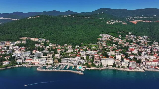 Opatija, Croatia - 4K flying by Opatija, a beautiful town of the Adriatic on a sunny hot summer day with beaches, red rooftops and blue sky and sea water